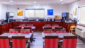 A modern kitchen with a central island, equipped with various appliances and a coffee station. - Comfort Inn Kennewick Richland (Kennewick)