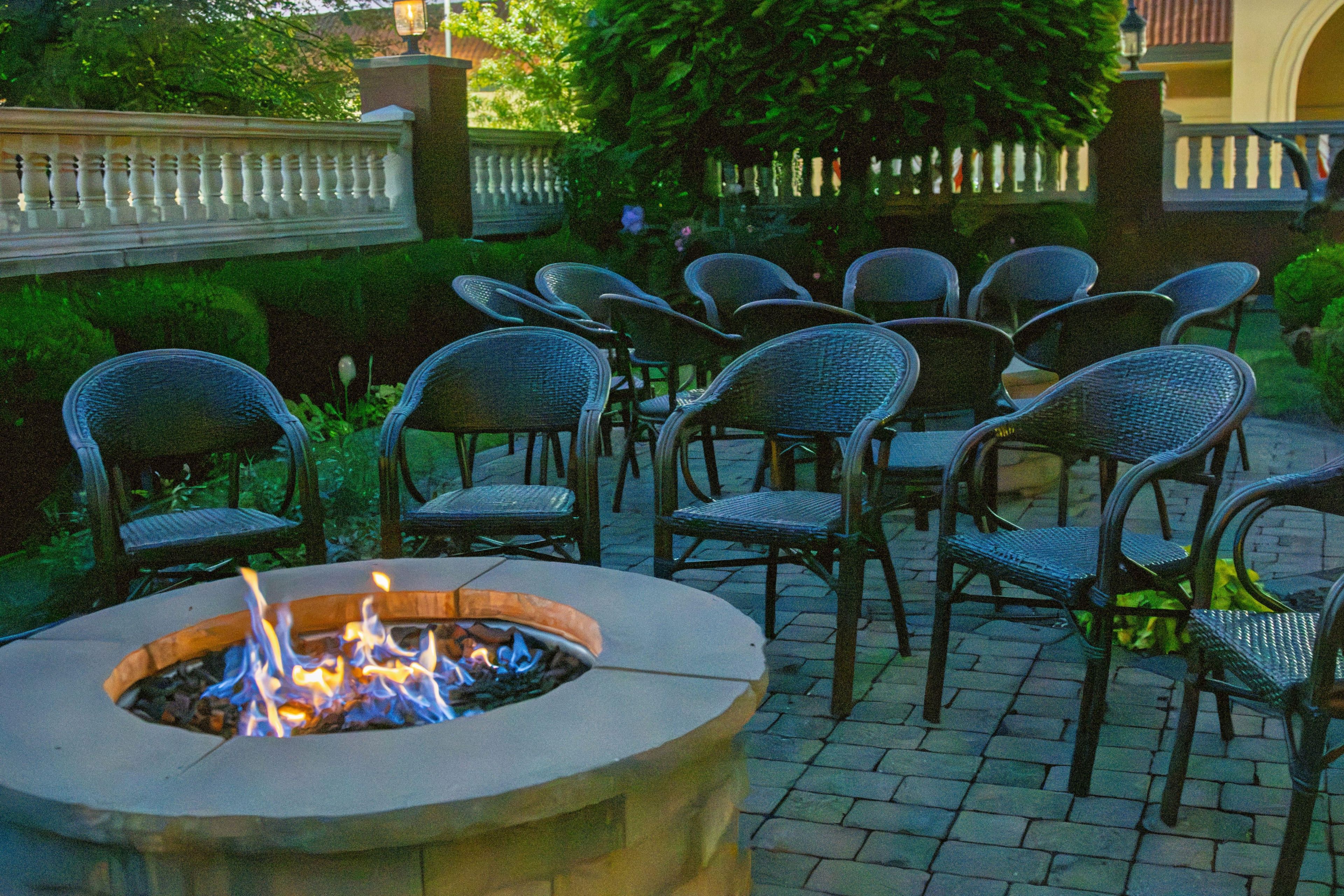A patio area with outdoor seating and a fire pit.
