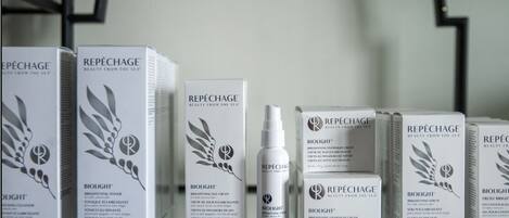 A shelf with various skincare products from the brand REPÉCHAGE, including boxes and a bottle.
