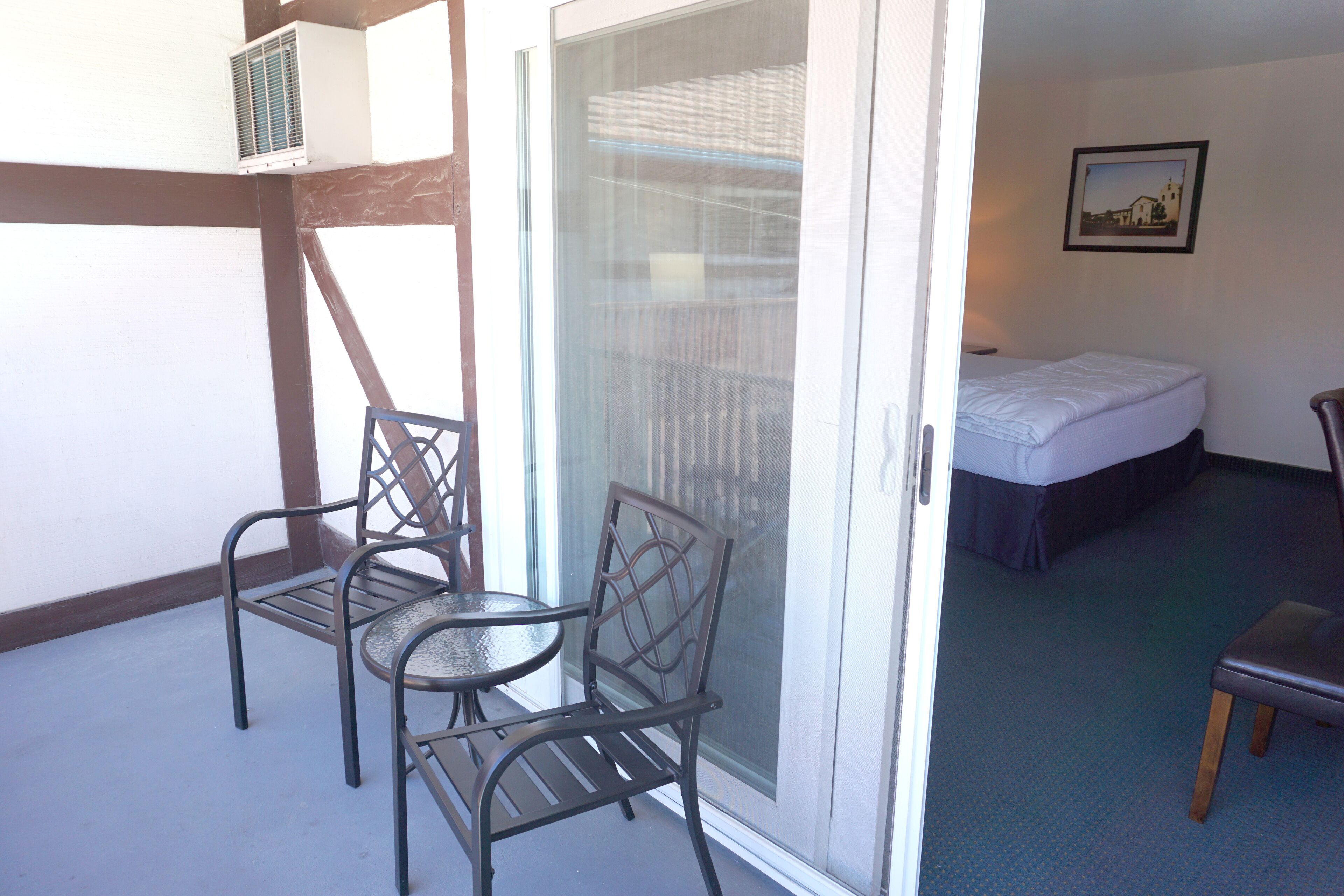 A room with a bed, a chair, and a table.