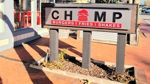 A sign for CHAMP Burgers, Fries, and Shakes.