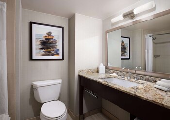 Combined shower/tub, designer toiletries, hair dryer, towels at Sonesta Redondo Beach & Marina
