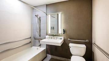 A modern bathroom with a bathtub, toilet, and sink.