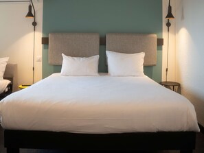 Premium bedding, desk, laptop workspace, blackout curtains