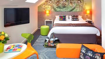 Relax in a stylish room with a large bed, flat-screen TV, and unique ceiling design.