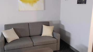 Suite, 1 King Bed, Non Smoking | Living area | 43-inch LCD TV with satellite channels, TV