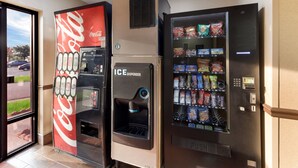 A Coca-Cola branded vending machine and an ICE dispenser in a commercial setting. - Red Roof Inn & Suites Columbus - West Broad (Columbus)