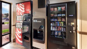 Vending machines with Coca-Cola and ICE dispensers, and a selection of snacks. - Red Roof Inn & Suites Columbus - West Broad (Columbus)