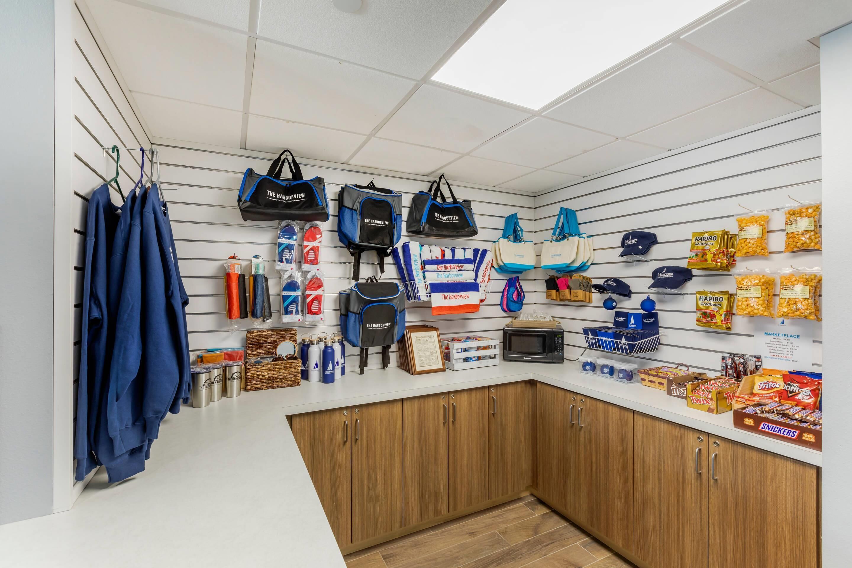 A retail store with hanging bags, clothing, and snacks.