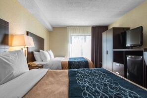 A hotel room with two beds, a TV, a minibar, and a large window with curtains. - Comfort Inn Trois-Rivières (Trois-Rivieres)