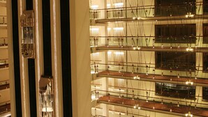 A multi-level hotel lobby with a central atrium, multiple floors, and a dining area with tables and chairs. - Pearl Continental Lahore (Lahore)