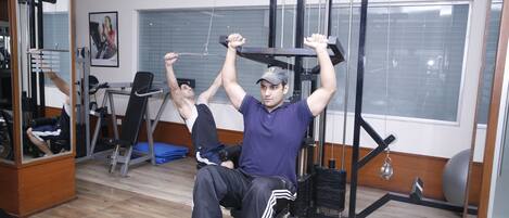 A gym with exercise equipment, including a pull-up bar and weight machines.