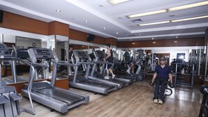 A gym with treadmills, weight machines, and mirrors. - Pearl Continental Lahore (Lahore)