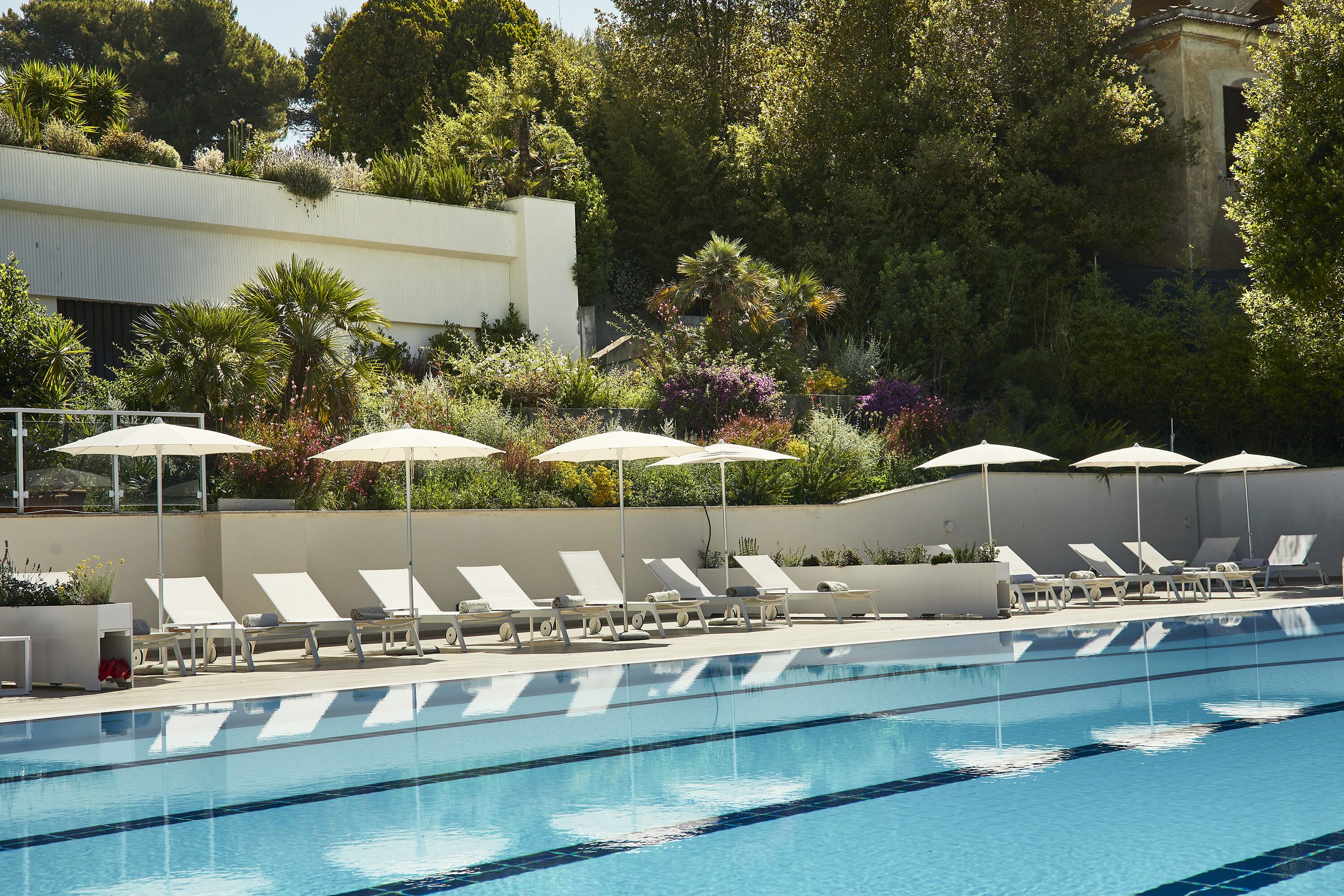 seasonal outdoor pool, open 8:00 am to 8:00 pm, pool umbrellas