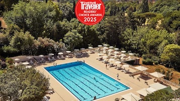 Seasonal outdoor pool, open 10:30 AM to 7:00 PM, pool umbrellas