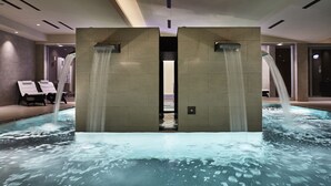 A modern indoor pool area with two water features and lounge chairs. - Hotel Villa Pamphili Roma (Rome)