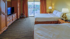 A hotel room with two beds, a television, a desk with a lamp, and a view of the city through a large window. - Motel 6 Phoenix, AZ – Sky Harbor (Phoenix)