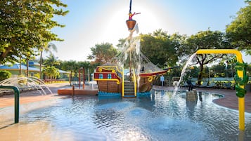 Explore the pirate ship attraction surrounded by water jets and fountains in a lively outdoor space.