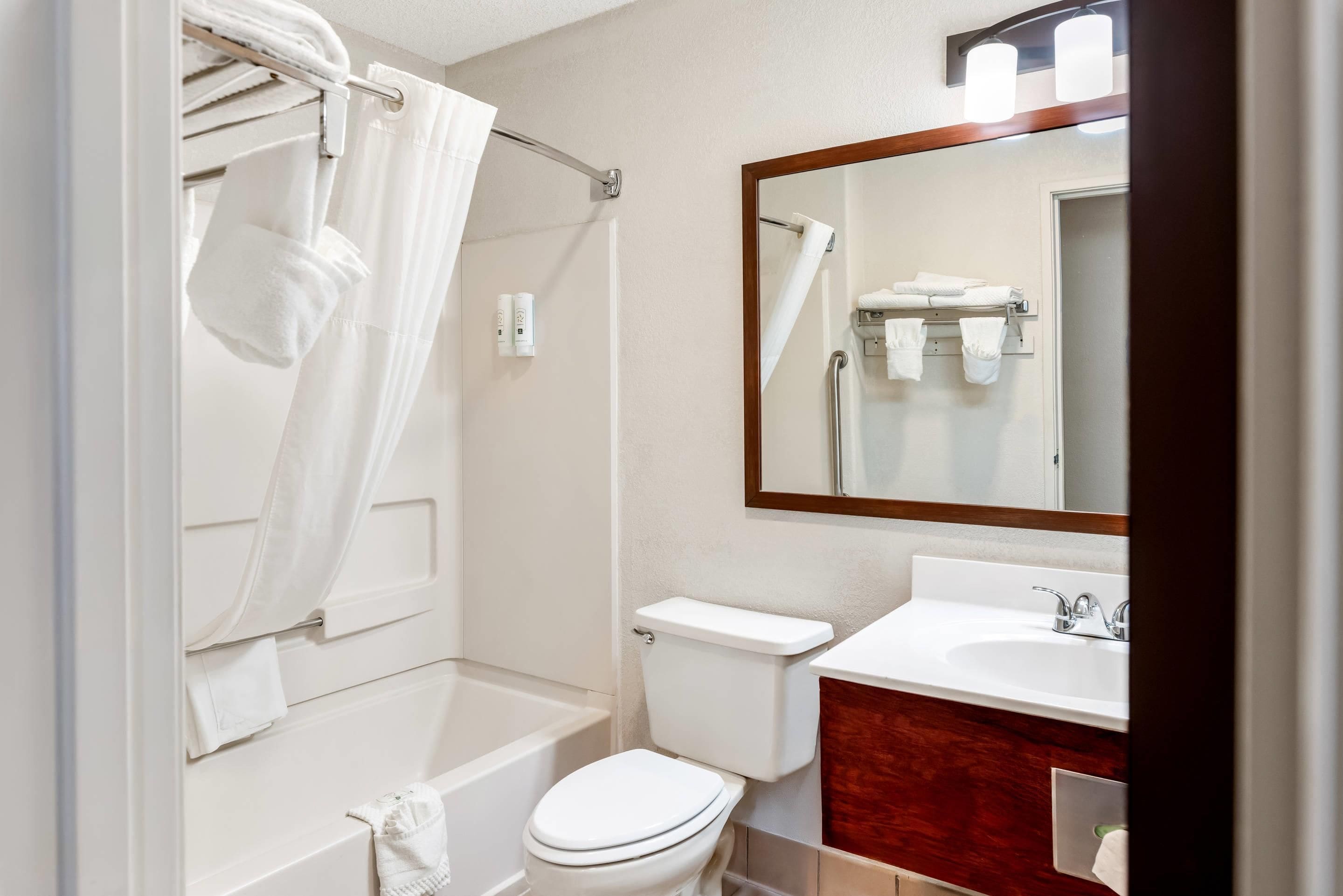 A bathroom with a bathtub, toilet, and sink.