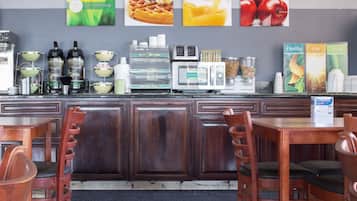A breakfast bar with seating, a coffee machine, and a toaster.