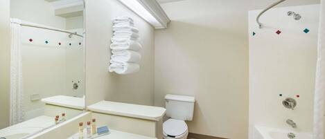 A bathroom with a sink, toilet, and shower.