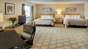 A hotel room with two beds, a desk with a chair, a TV, and artwork on the walls. - Comfort Inn Val-d Or (Val-d'Or)