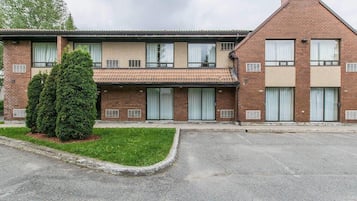 A two-story building with a flat roof, brick facade, and numbered windows.