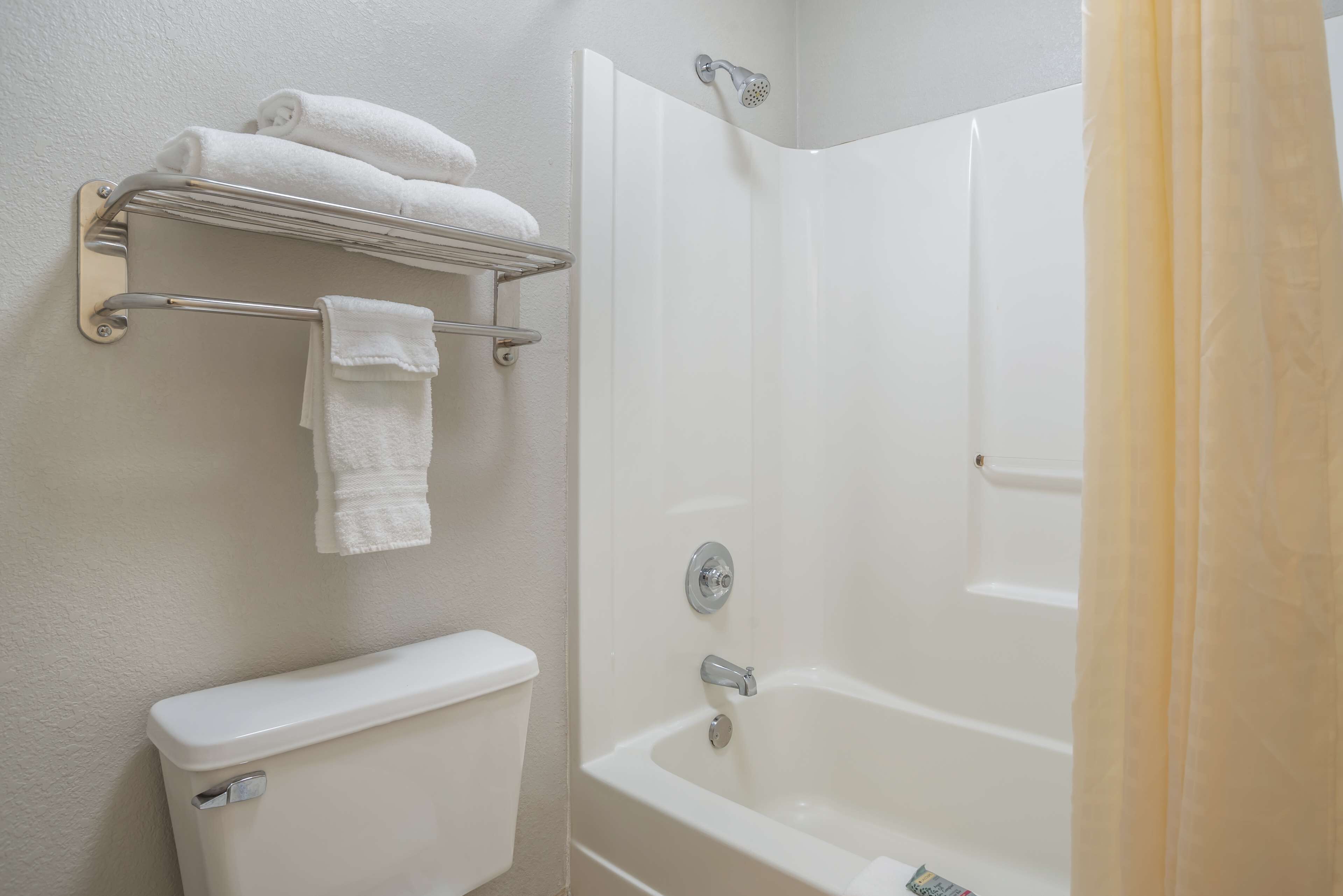 standard room, 2 queen beds, non smoking, refrigerator & microwave | bathroom | combined shower/bathtub, free toiletries, hair dryer, towels