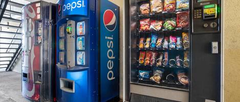 A vending machine area with Pepsi branding and a variety of snack options.