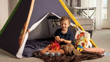 Relax in the Ritzkids tent, complete with a plush lion and a decorative item.