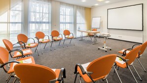 A conference room with a whiteboard, projector, and multiple orange chairs with documents. - Best Western Plus Hotel Am Schlossberg (Nuertingen)