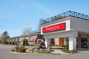 Experience the stylish exterior of Ramada By Wyndham, featuring a modern design and beautifully landscaped gardens.