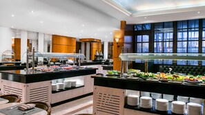 A buffet setup with various food items and a seating area with chairs. - Sonesta Hotel Tower & Casino Cairo (Cairo)