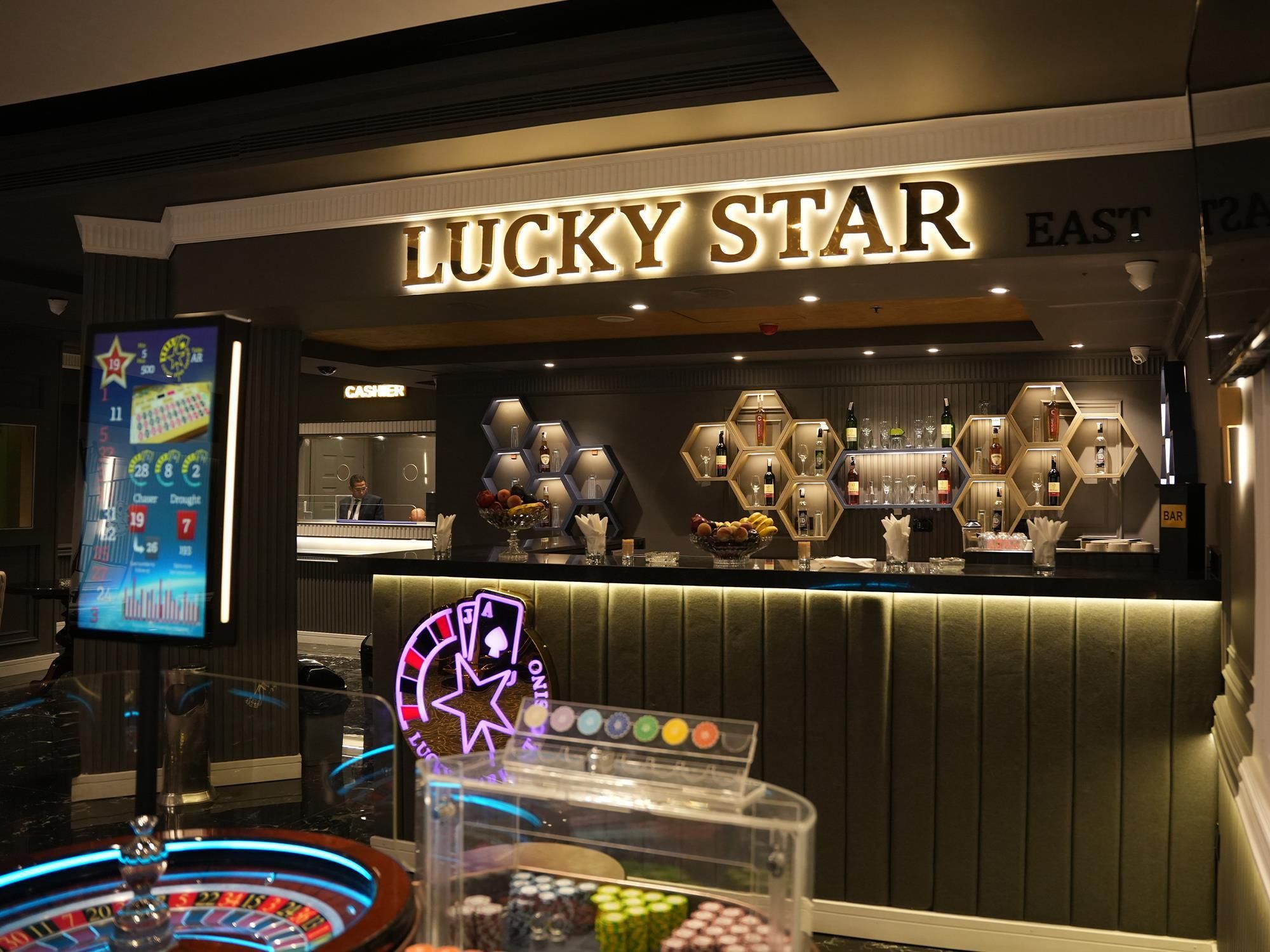 A casino area with a roulette wheel, a slot machine, and a bar named 'Lucky Star.'