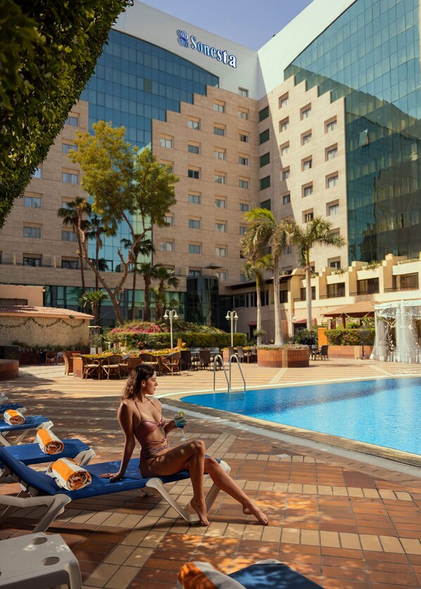 A hotel pool area with lounge chairs, a swimming pool, and a building with the name "Sonesta" visible. - Sonesta Hotel, Tower & Casino - Cairo (Cairo)