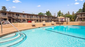 Seasonal outdoor pool, open 9:00 AM to 9:00 PM, pool umbrellas