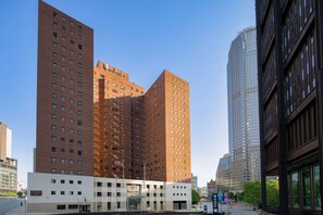 Stylish urban hotel with a red-brick facade and symmetrical design.