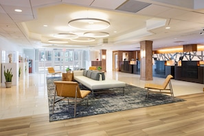 Relax in our inviting lobby, featuring a comfortable seating area with a sofa and armchairs.