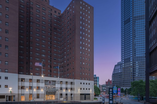 DoubleTree by Hilton hotel features a modern red brick facade with the hotel's name prominently displayed.