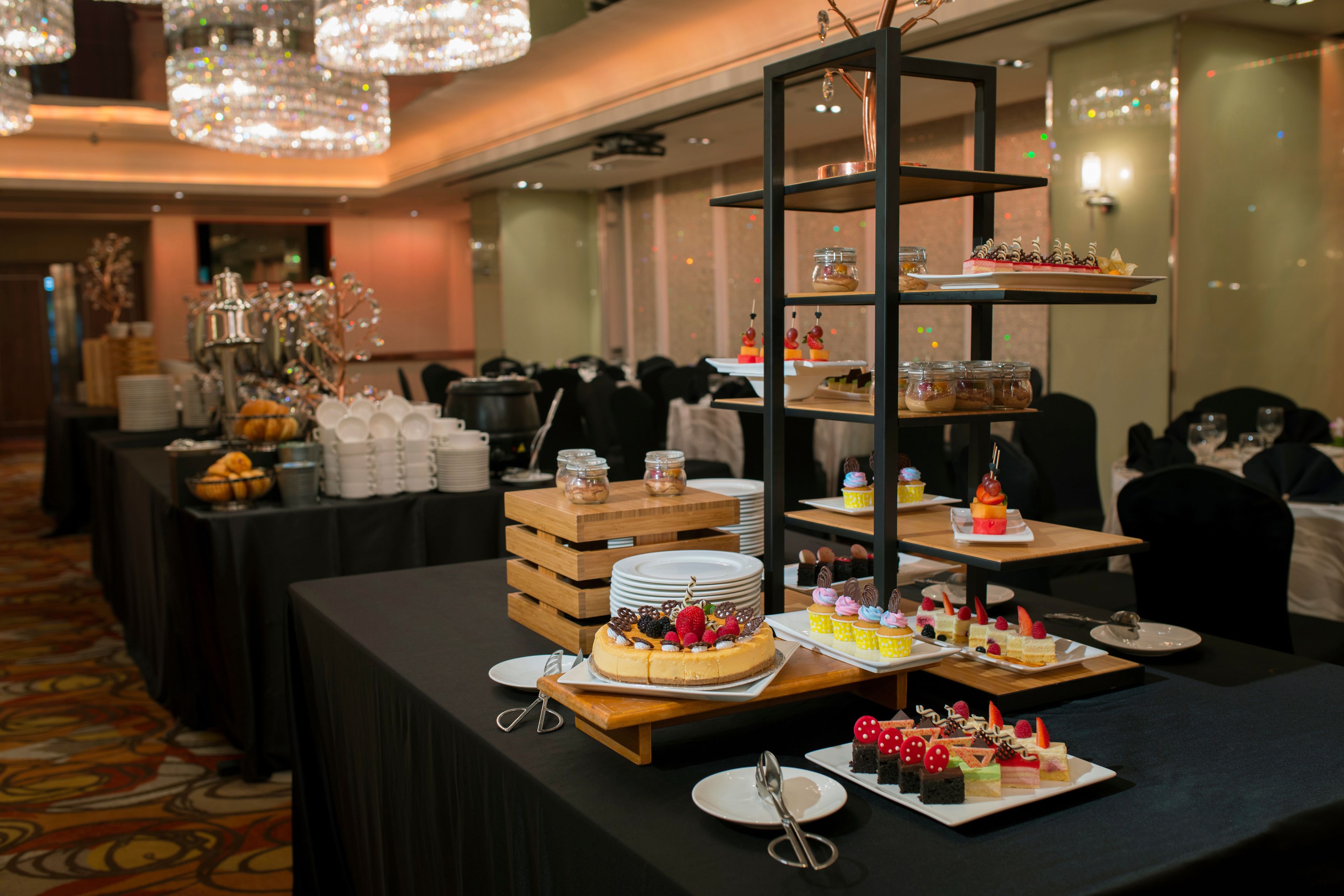 A buffet setup with various desserts and food items on display.