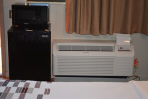 Enjoy a convenient kitchenette with a microwave and refrigerator, perfect for preparing meals.