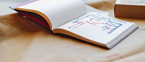 An open book with architectural drawings on a table.