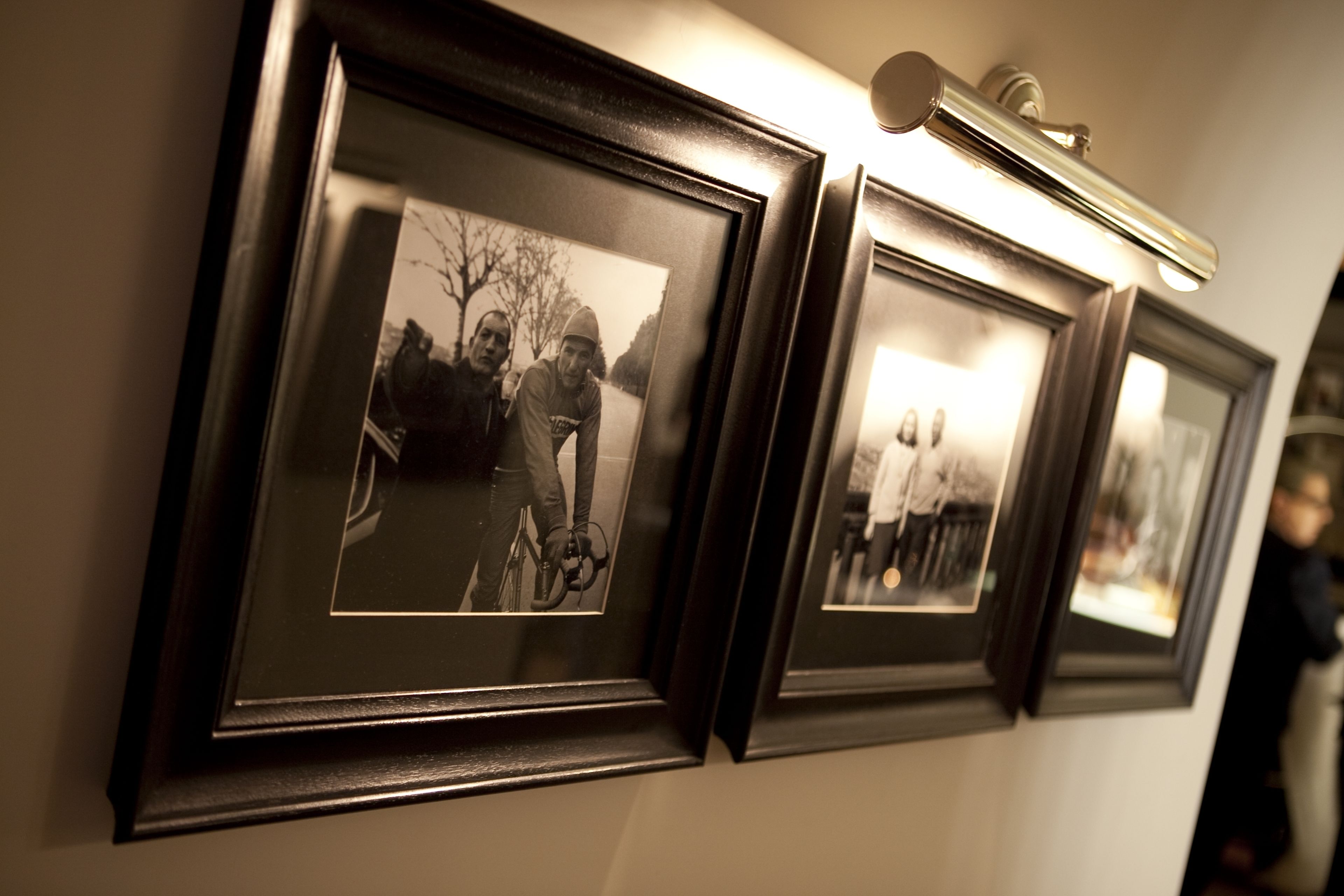 A wall with framed photographs.