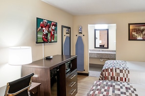 A hotel room with a TV, desk, chair, bed, and bathroom. - Red Roof Inn Indianapolis East (Indianapolis)