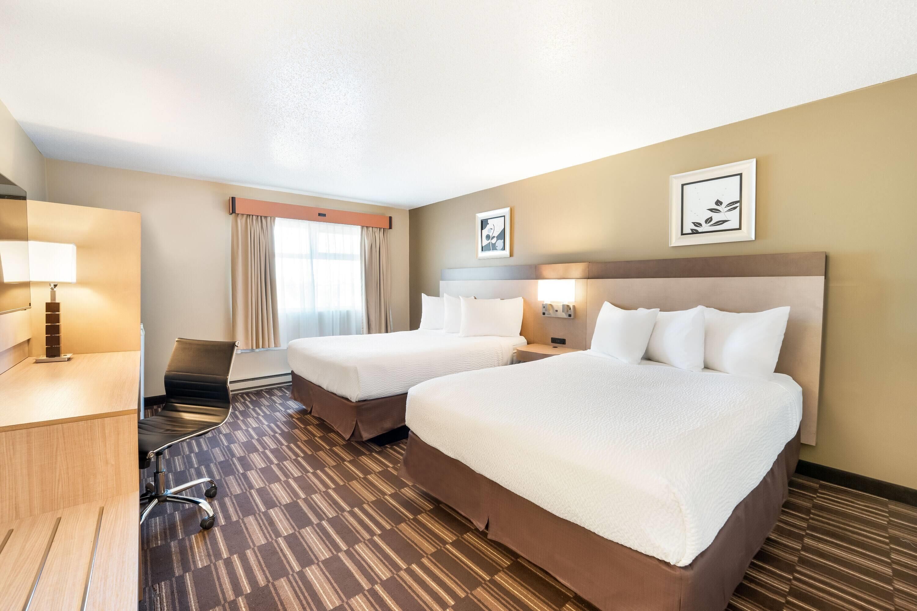 2 Queen Beds (Pool Level) Non-pet friendly | Desk, blackout drapes, iron/ironing board, free cribs/infant beds