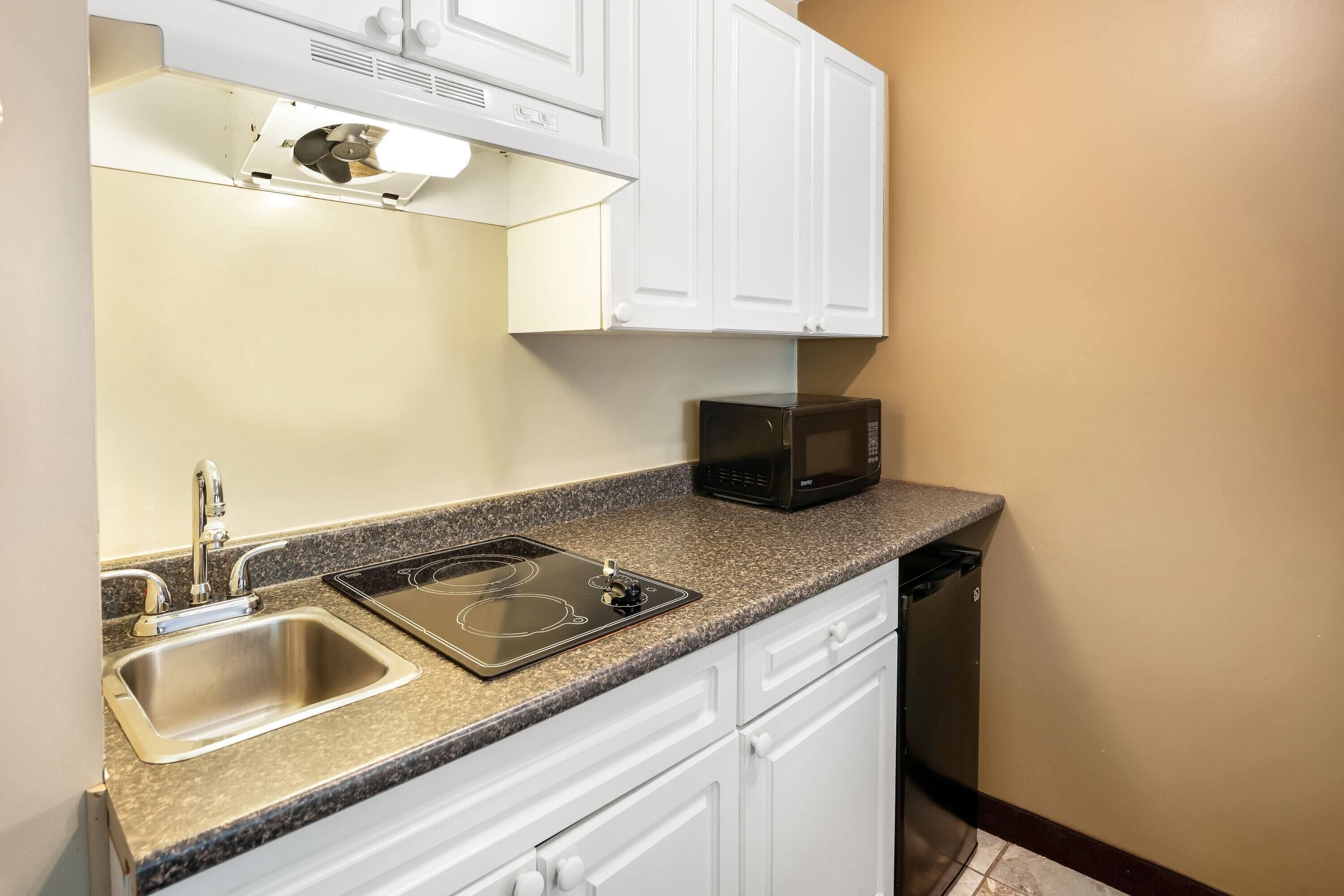 2 Queen Beds + Kitchenette Non-pet friendly | Desk, blackout drapes, iron/ironing board, free cribs/infant beds