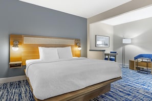 A hotel room with a large bed, a desk, a chair, a lamp, and a framed picture on the wall. - Best Western St. Louis Fairview Heights (Fairview Heights)