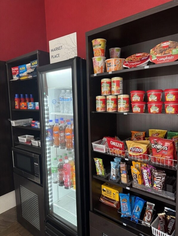 A vending machine with a variety of drinks and snacks, including sodas, juices, and chips. - Ramada by Wyndham Harrisonburg (Harrisonburg)