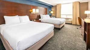 A hotel room with two beds, a desk, a chair, and a window with curtains. - Comfort Inn & Conference Centre Toronto Airport (Toronto)