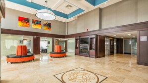 A spacious lobby with a high ceiling, modern lighting, and a central decorative rug. - Comfort Inn & Conference Centre Toronto Airport (Toronto)